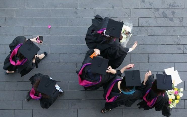 University students in mortar boards and cloaks on graduation day