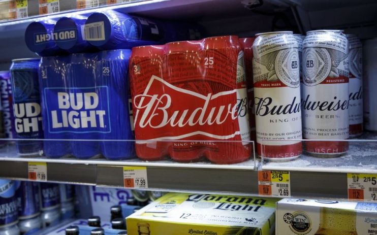 Budweiser maker AB inBev backed its full year guidance despite reporting a fall in volumes due to weak demand in the US and soft industry in Europe in the third quarter.