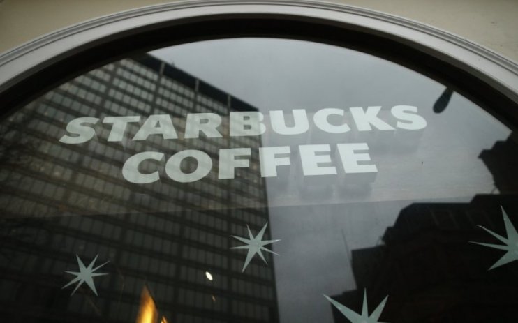 Starbucks UK has outlined plans to open 100 new stores as it delivered strong trading in the face of a weak consumer market.