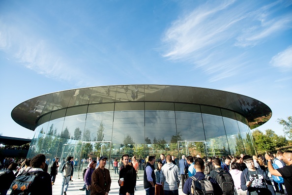 Attendees gather for a product launch event at Apple's Steve Jobs Theater on September 12, 2018, in Cupertino, California. - New iPhones set to be unveiled Wednesday offer Apple a chance for fresh momentum in a sputtering smartphone market as the California tech giant moves into new products and services to diversify.Apple was expected to introduce three new iPhone models at its media event at its Cupertino campus, notably seeking to strengthen its position in the premium smartphone market a year after launching its $1,000 iPhone X. (Photo by NOAH BERGER / AFP) (Photo credit should read NOAH BERGER/AFP/Getty Images)