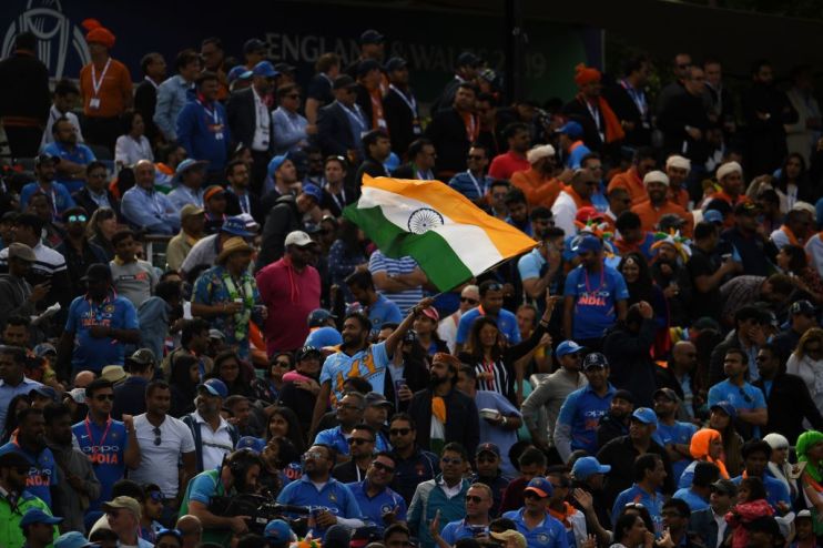 India's supporters wave a national flag during the 2019 Cricket World Cup group stage match between India and Australia at The Oval in London on June 9, 2019. (Photo by Dibyangshu SARKAR / AFP) / RESTRICTED TO EDITORIAL USE (Photo credit should read DIBYANGSHU SARKAR/AFP/Getty Images)