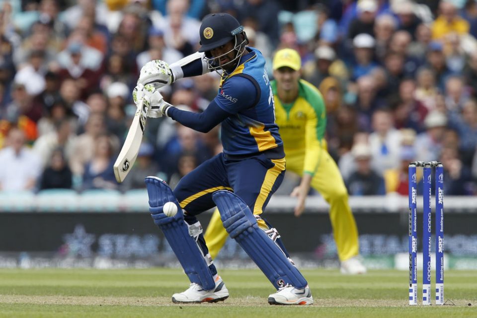 Sri Lanka's captain Dimuth Karunaratne plays a shot during the 2019 Cricket World Cup group stage match between Sri Lanka and Australia at The Oval in London on June 15, 2019. (Photo by Ian KINGTON / AFP) / RESTRICTED TO EDITORIAL USE (Photo credit should read IAN KINGTON/AFP/Getty Images)