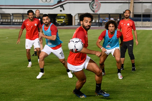 Egypt's forward Mohamed Salah (C) Egypt's defender Abdullah al-Saeed (2nd-L) and Egypt's midfielder Amr Warda (2nd-R) vie for the ball during a training session two days ahead of their opening match against Zimbabwe in the 2019 football Africa Cup of Nations (CAN) on June 19, 2019 at the Cairo Military Academy Stadium in the Egyptian capital. (Photo by Khaled DESOUKI / AFP) (Photo credit should read KHALED DESOUKI/AFP/Getty Images)