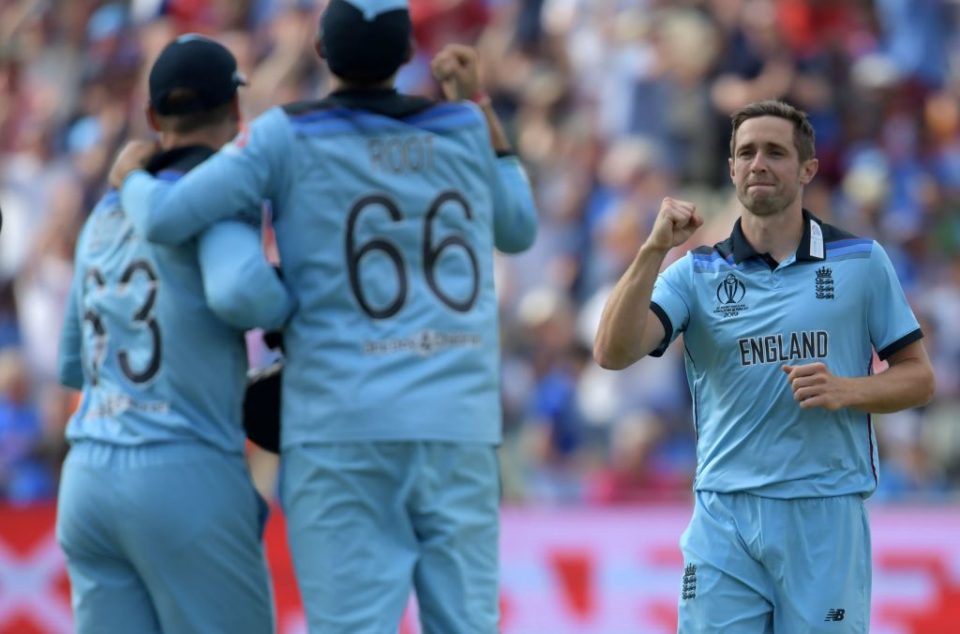 England's Chris Woakes (R) celebrates after the dismissal of India's Rohit Sharma during the 2019 Cricket World Cup group stage match between England and India at Edgbaston in Birmingham, central England, on June 30, 2019. (Photo by Dibyangshu Sarkar / AFP) / RESTRICTED TO EDITORIAL USE        (Photo credit should read DIBYANGSHU SARKAR/AFP/Getty Images)