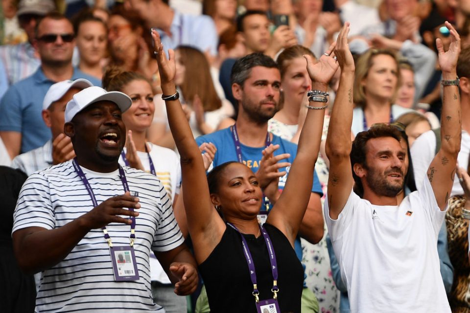 The team of US player Cori Gauff, including her father Corey (L), mother Candi (C) and French tennis coach Jean-Christophe Faurel (R) celebrate after Gauff beat Slovenia's Polona Hercog during their women's singles third round match on the fifth day of the 2019 Wimbledon Championships at The All England Lawn Tennis Club in Wimbledon, southwest London, on July 5, 2019. (Photo by Daniel LEAL-OLIVAS / AFP) / RESTRICTED TO EDITORIAL USE (Photo credit should read DANIEL LEAL-OLIVAS/AFP/Getty Images)