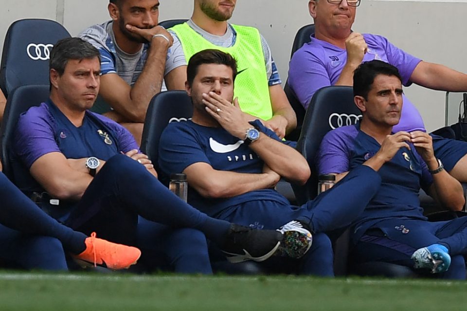 Tottenham Hotspur's Argentinian head coach Mauricio Pochettino (C) gestures in his seat during the English Premier League football match between Tottenham Hotspur and Newcastle United at Tottenham Hotspur Stadium in London, on August 25, 2019. (Photo by Daniel LEAL-OLIVAS / AFP) / RESTRICTED TO EDITORIAL USE. No use with unauthorized audio, video, data, fixture lists, club/league logos or 'live' services. Online in-match use limited to 120 images. An additional 40 images may be used in extra time. No video emulation. Social media in-match use limited to 120 images. An additional 40 images may be used in extra time. No use in betting publications, games or single club/league/player publications. / (Photo credit should read DANIEL LEAL-OLIVAS/AFP/Getty Images)