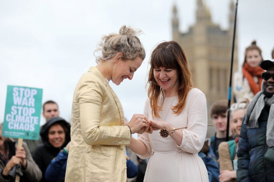 Tasmin (L) and Melissa take part in a blessing ahead of their wedding day, surrounded by activists from the climate change group Extinction Rebellion, during a demonstration on Westminster Bridge in central London, on October 7, 2019. - Extinction Rebellion has scheduled non-violent protests chiefly in Europe, North America and Australia over the next fortnight. (Photo by ISABEL INFANTES / AFP) (Photo by ISABEL INFANTES/AFP via Getty Images)