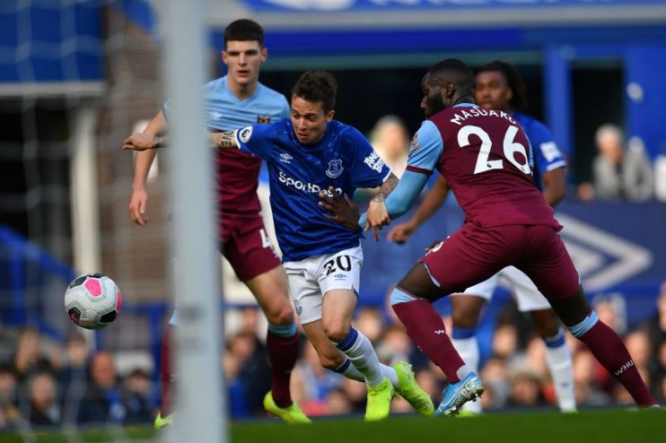 Everton's Brazilian striker Bernard (C) scores his team's first goal during the English Premier League football match between Everton and West Ham United at Goodison Park in Liverpool, north west England on October 19, 2019. (Photo by Paul ELLIS / AFP) / RESTRICTED TO EDITORIAL USE. No use with unauthorized audio, video, data, fixture lists, club/league logos or 'live' services. Online in-match use limited to 120 images. An additional 40 images may be used in extra time. No video emulation. Social media in-match use limited to 120 images. An additional 40 images may be used in extra time. No use in betting publications, games or single club/league/player publications. / (Photo by PAUL ELLIS/AFP via Getty Images)