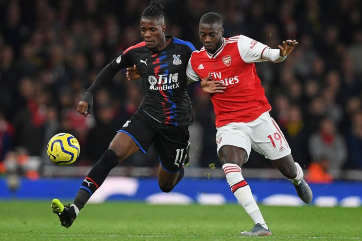 Crystal Palace's Ivorian striker Wilfried Zaha (L) vies with Arsenal's French-born Ivorian midfielder Nicolas Pepe (R) during the English Premier League football match between Arsenal and Crystal Palace at the Emirates Stadium in London on October 27, 2019. (Photo by DANIEL LEAL-OLIVAS / AFP) / RESTRICTED TO EDITORIAL USE. No use with unauthorized audio, video, data, fixture lists, club/league logos or 'live' services. Online in-match use limited to 120 images. An additional 40 images may be used in extra time. No video emulation. Social media in-match use limited to 120 images. An additional 40 images may be used in extra time. No use in betting publications, games or single club/league/player publications. / (Photo by DANIEL LEAL-OLIVAS/AFP via Getty Images)