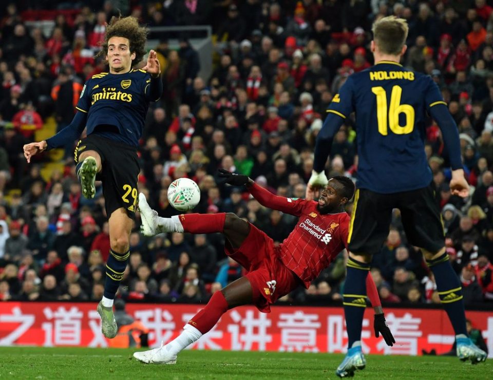 Liverpool's Belgium striker Divock Origi (C) scores his team's fifth goal during the English League Cup fourth round football match between Liverpool and Arsenal at Anfield in Liverpool, north west England on October 30, 2019. (Photo by Paul ELLIS / AFP) / RESTRICTED TO EDITORIAL USE. No use with unauthorized audio, video, data, fixture lists, club/league logos or 'live' services. Online in-match use limited to 75 images, no video emulation. No use in betting, games or single club/league/player publications. / (Photo by PAUL ELLIS/AFP via Getty Images)
