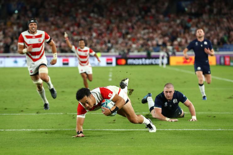 YOKOHAMA, JAPAN - OCTOBER 13: Kenki Fukuoka of Japan dives to score their third try as Scotland player Stuart Hogg reacts during the Rugby World Cup 2019 Group A game between Japan and Scotland at International Stadium Yokohama on October 13, 2019 in Yokohama, Kanagawa, Japan. (Photo by Stu Forster/Getty Images)