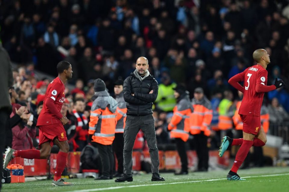 Manchester City's Spanish manager Pep Guardiola (C) watches the Liverpool team run out at the start of the second half during the English Premier League football match between Liverpool and Manchester City at Anfield in Liverpool, north west England on November 10, 2019. (Photo by Paul ELLIS / AFP) / RESTRICTED TO EDITORIAL USE. No use with unauthorized audio, video, data, fixture lists, club/league logos or 'live' services. Online in-match use limited to 120 images. An additional 40 images may be used in extra time. No video emulation. Social media in-match use limited to 120 images. An additional 40 images may be used in extra time. No use in betting publications, games or single club/league/player publications. / (Photo by PAUL ELLIS/AFP via Getty Images)