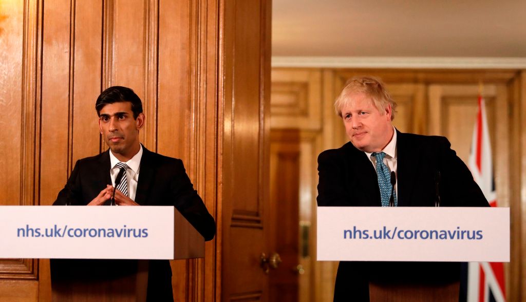 Britain's Chancellor of the Exchequer Rishi Sunak (L) and Britain's Prime Minister Boris Johnson (R) attend a news conference addressing the government's response to the novel coronavirus COVID-19 outbreak, inside 10 Downing Street in London on March 17, 2020 - Britain on Tuesday, March 17, ramped up its response to the escalating coronavirus outbreak after the government imposed unprecedented peacetime measures prompted by scientific advice that infections and deaths would spiral without drastic action. (Photo by Matt Dunham / POOL / AFP) (Photo by MATT DUNHAM/POOL/AFP via Getty Images)