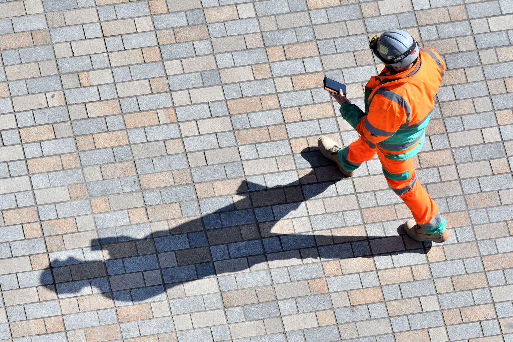 A construction worker working on the Thames Tideway scheme walks in south London on March 24, 2020,  as Britain's Chancellor of the Duchy of Lancaster, Michael Gove  clarified that major construction work should go ahead but jobs carried out at close quarters in someone's home would not be appropriate due to the novel coronavirus COVID-19. - Britain was under lockdown March 24, its population joining around 1.7 billion people around the globe ordered to stay indoors to curb the "accelerating" spread of the coronavirus. (Photo by JUSTIN TALLIS / AFP) (Photo by JUSTIN TALLIS/AFP via Getty Images)