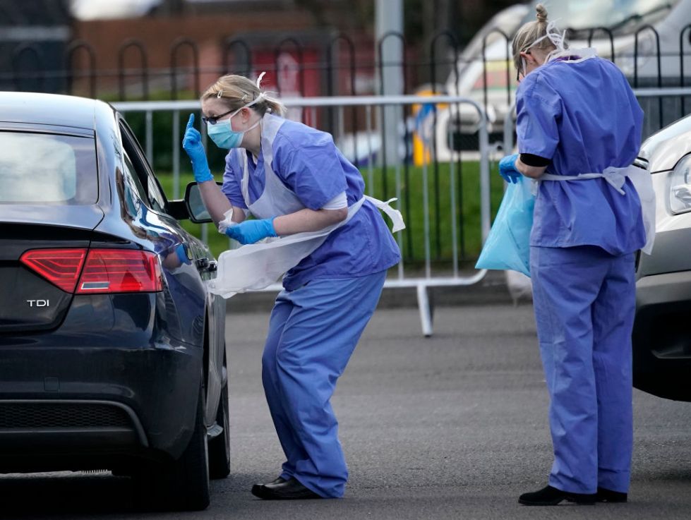 A member of the public is swabbed at a drive through Coronavirus testing site