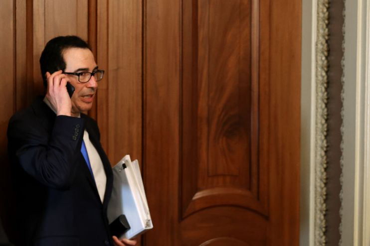 Treasury secretary Steven Mnuchin (centre) leaves the offices of Democrat Charles Schumer as the US rushes to finalise a $2 trillion coronavirus stimulus bill