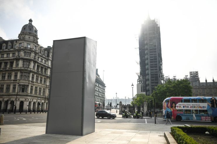 A protective barrier  is seen around the statue of Winston Churchill in London's Parliament Square in anticipation of protests today