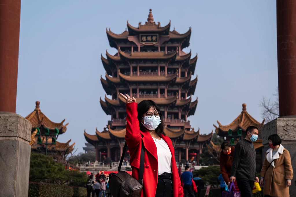A woman poses in the Yellow Crane Tower Park in Wuhan, Hubei Province, China