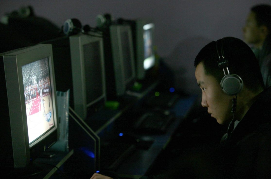 A man surfs the internet at a cafe in Chongqing (Photo by China Photos/Getty Images)