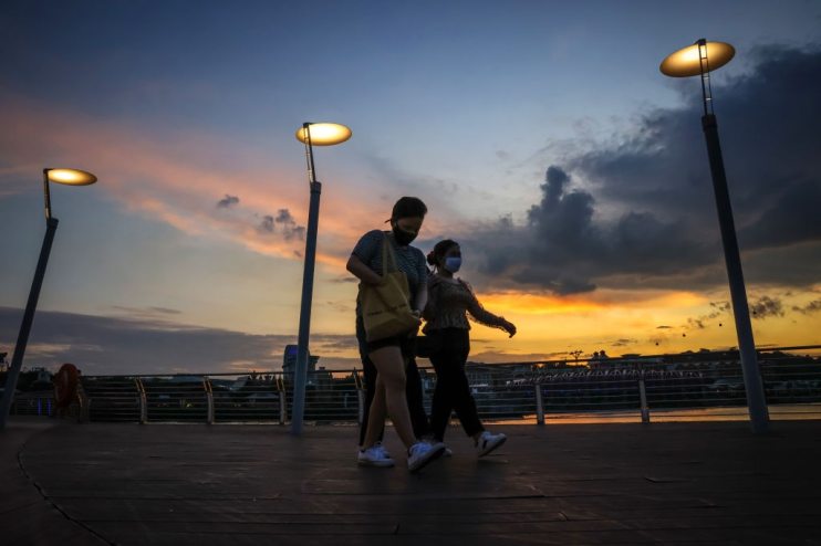 People wear face masks in Singapore