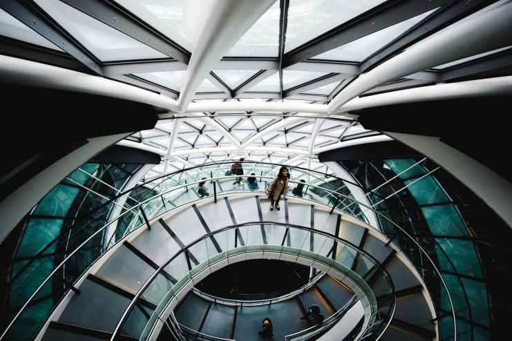 photo of woman standing on spiral staircase