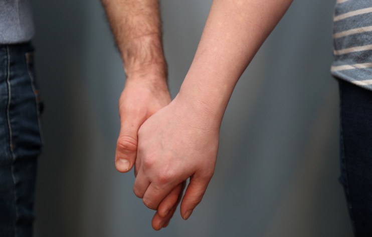 A married couple holding hands
