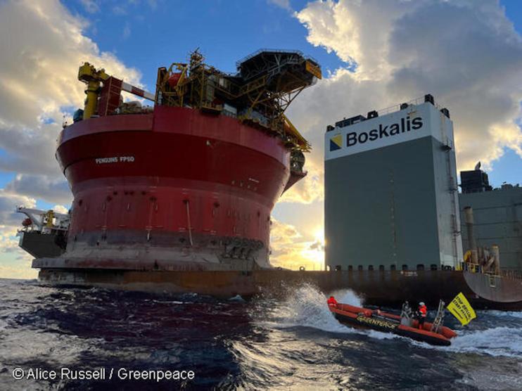 Greenpeace activists in inflatable boats approaching Shell platform. Greenpeace activists in inflatable boats approaching Shell platform.