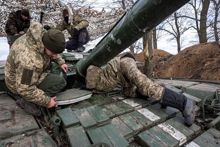 Ukrainian Marines prepare their T-64 tank for action while dug in to a treeline on February 15, 2023 in the Donbass region of eastern Ukraine. Russian forces have been attacking Ukrainian positions all across the country's east in a winter offensive. Ukrainian tank commanders there said they are looking forward to the arrival of modern European and American tanks to upgrade their aging fleet of Soviet era vehicles. (Photo by John Moore/Getty Images)