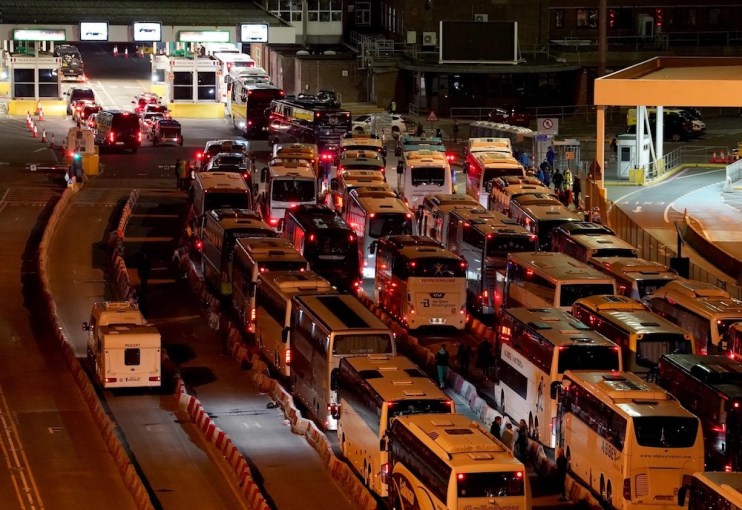 Coaches wait in to the evening to enter the Port of Dover in Kent after extra sailings were run overnight to try and clear the backlog which has left passengers stuck in Easter traffic for hours.