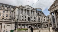 Bank of England building with City investors concerned about interest rate cut decisions, reflecting market uncertainty
