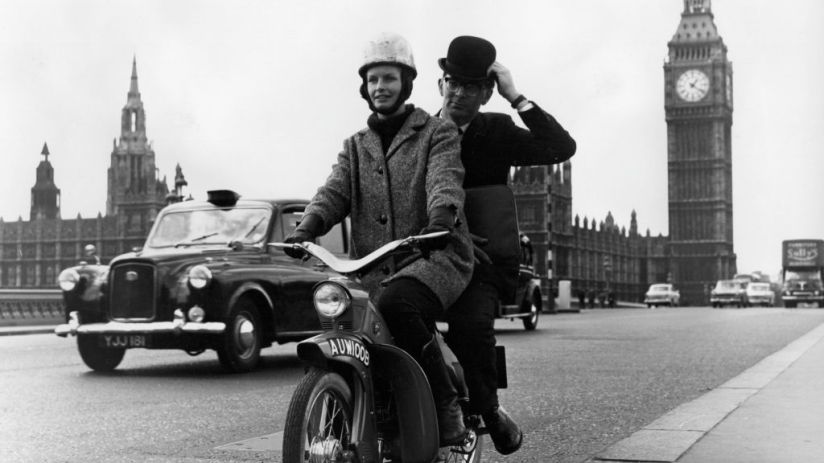 A moped taxi on a test run over Westminster Bridge, London.