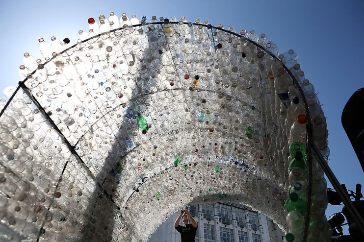 SAN FRANCISCO, CA - MARCH 22: Merijn Everaarts makes adjustments to a 14-foot wave made of plastic bottles on March 22, 2013 in San Francisco, California. The Dopper Foundation marked United Nations' World Water Day by inviting people to have their photo taken while standing on a surfboard on a 14-foot wave comprised of 6,000 single-use water bottles. The installation is intended to raise awareness to reduce plastic waste that litters oceans and waterways. (Photo by Justin Sullivan/Getty Images)