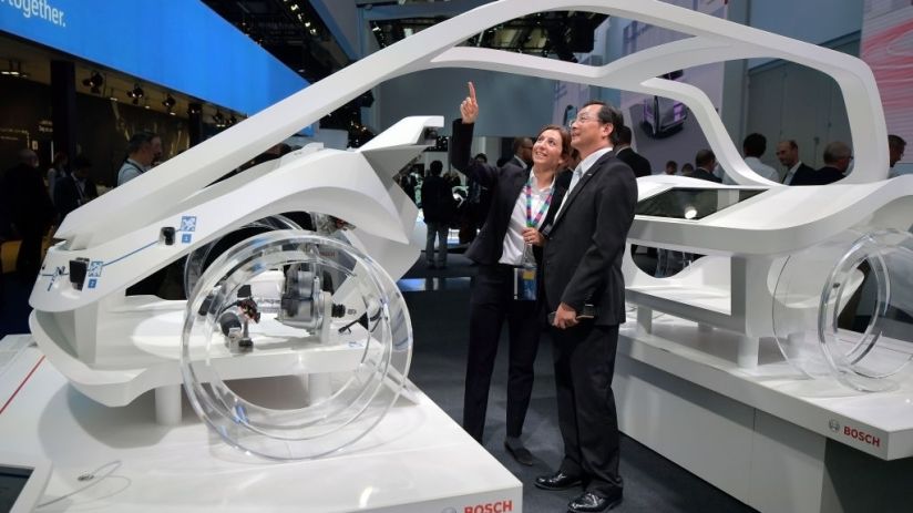Visitors look at a concept car of the German auto parts manufacturer Robert Bosch GmbH at the 2017 Frankfurt Auto Show 'Internationale Automobil Ausstellung' (IAA) on September 12, 2017 in Frankfurt am Main, Germany. The Frankfurt Auto Show is taking place during a turbulent period for the auto industry. Leading companies have been rocked by the self-inflicted diesel emissions scandal. At the same time the industry is on the verge of a new era as automakers commit themselves more and more to a future that will one day be dominated by electric cars. (Photo by Thomas Lohnes/Getty Images)
