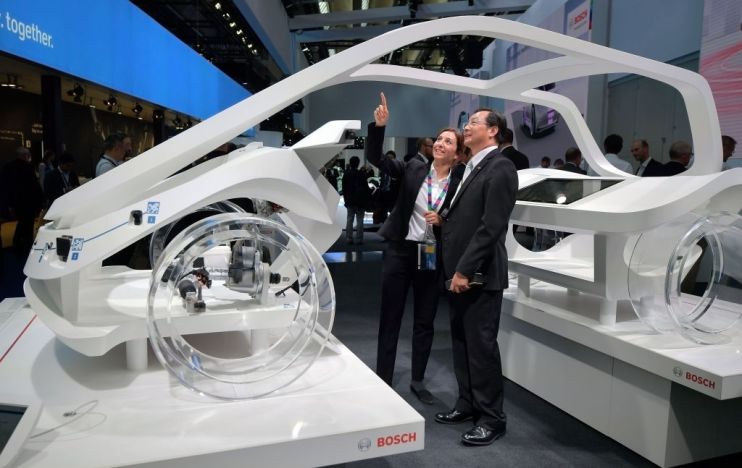 Visitors look at a concept car of the German auto parts manufacturer Robert Bosch GmbH at the 2017 Frankfurt Auto Show 'Internationale Automobil Ausstellung' (IAA) on September 12, 2017 in Frankfurt am Main, Germany. The Frankfurt Auto Show is taking place during a turbulent period for the auto industry. Leading companies have been rocked by the self-inflicted diesel emissions scandal. At the same time the industry is on the verge of a new era as automakers commit themselves more and more to a future that will one day be dominated by electric cars. (Photo by Thomas Lohnes/Getty Images)