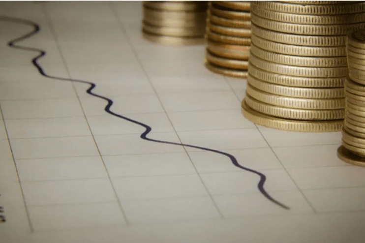 Paper graph with coins on.