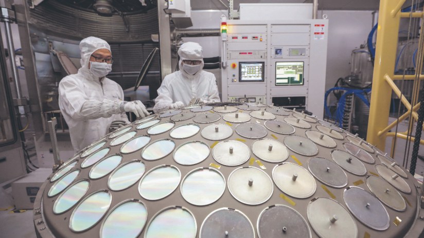Employees work on the production line of semiconductor wafer at a factory of Jiangsu Azure Corporation Cuoda Group Co., Ltd. (Photo by VCG/VCG via Getty Images)