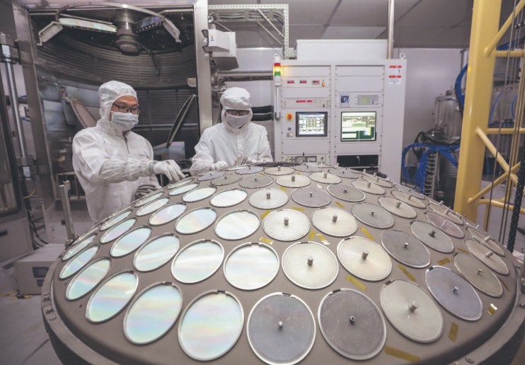 Employees work on the production line of semiconductor wafer at a factory of Jiangsu Azure Corporation Cuoda Group Co., Ltd. (Photo by VCG/VCG via Getty Images)