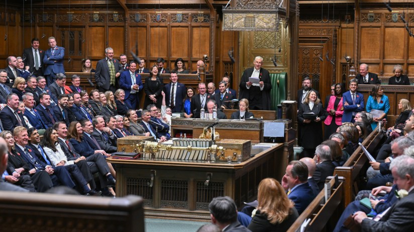 Emergency services have been called to the Palace of Westminster where a man has scaled one of the buildings.