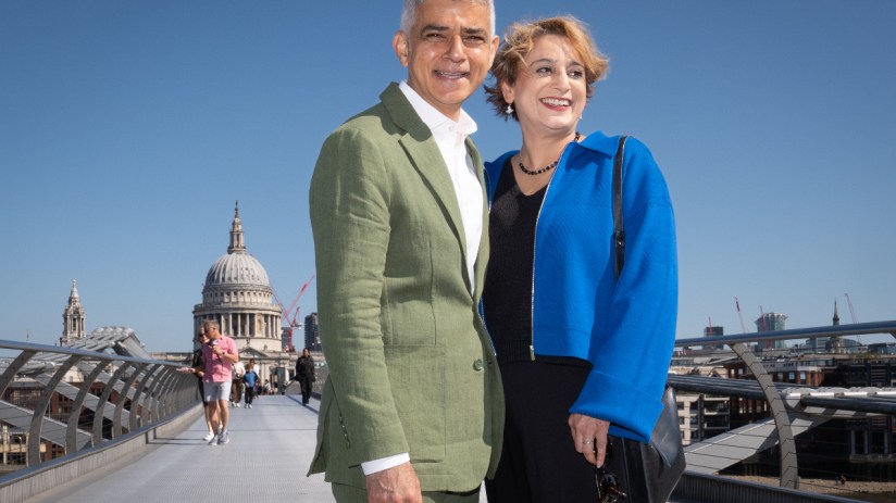 Sadiq Khan and his wife Saadiya walk across the Millennium Bridge. Photo: PA