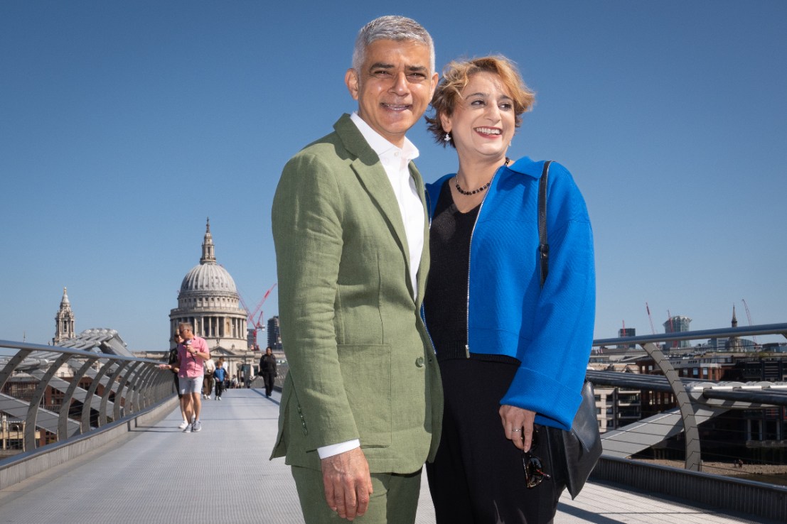 Sadiq Khan and his wife Saadiya walk across the Millennium Bridge. Photo: PA
