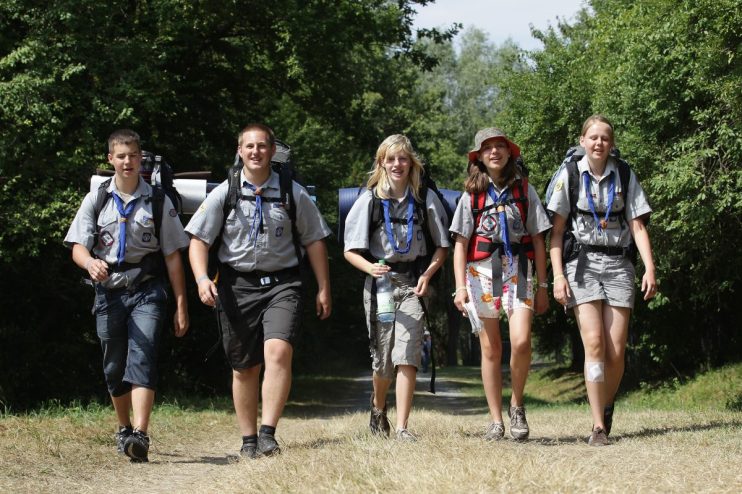 ALMKE, GERMANY - AUGUST 01: Scouts hiking through a woodland on August 1, 2010 in Almke near Wolfsburg, Germany. About 5000 young scouts from Germany, Russia, Belgium, Suisse, USA and Italy aged 12 to 20 participate in a camp. Since 1973, the German VCP-Christian Guides and Pathfinders organisation, offers an International historic boys and girls scout meeting during the summer holidays. On a 25 hectare field include 1370 tens, a tent church and a tent theater. The Federal camp is held every four years. (Photo by Andreas Rentz/Getty Images)