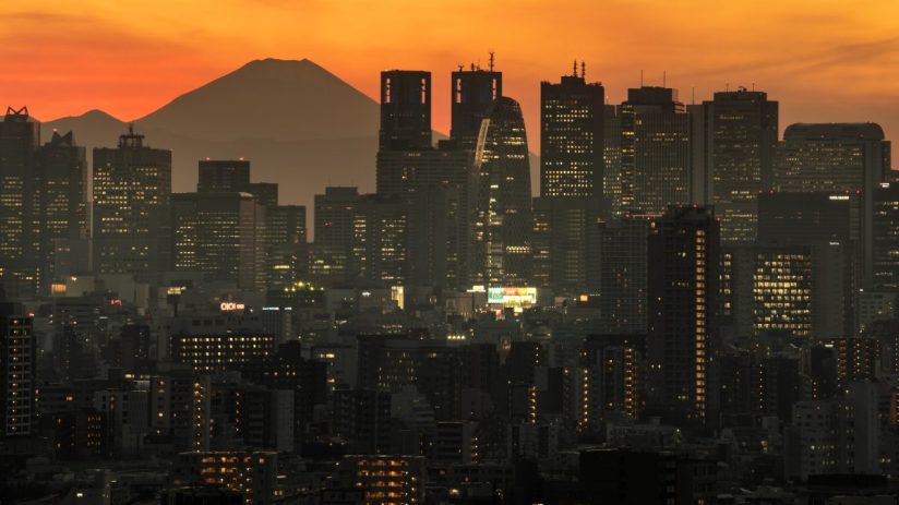 TOKYO, JAPAN - DECEMBER 23: Mount Fuji is seen behind the city skyline at dusk on December 23, 2020 in Tokyo, Japan. (Photo by Carl Court/Getty Images)