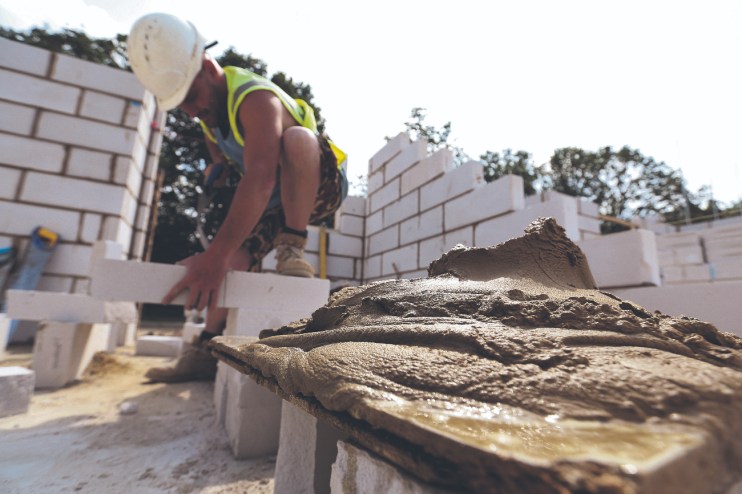 Crest rejected a bid from Bellway. Here a construction worker cuts a breeze block brick to size for a new home under construction at a Crest Nicholson Holdings residential housing development Photographer: Chris Ratcliffe/Bloomberg via Getty Images