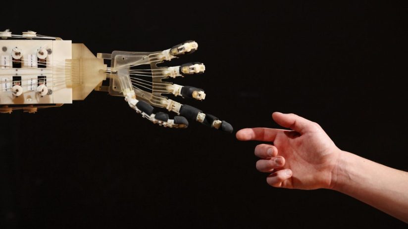 LONDON, ENGLAND - NOVEMBER 29: Robotics student Gildo Andreoni interacts with a Dexmart robotic hand built at the University of Bologna in the Robotville exhibition at the Science Museum on November 29, 2011 in London, England. The Science Museum's Robotville exhibition showcases 20 unique and cutting-edge robots from European research laboratories, it is free to enter and runs from December 1-4, 2011. (Photo by Oli Scarff/Getty Images)