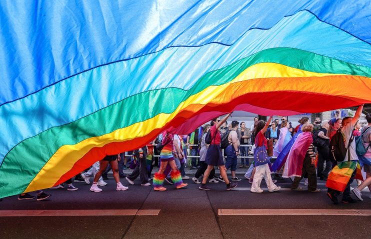 BERLIN, GERMANY - JULY 22: Participants hold a big pride rainbow flag during the annual Christopher Street Day parade on July 22, 2023 in Berlin, Germany. CSD Berlin is among Europe's biggest Pride events and is a demonstration and celebration of the rights of LGBTQIA+ people. (Photo by Omer Messinger/Getty Images)