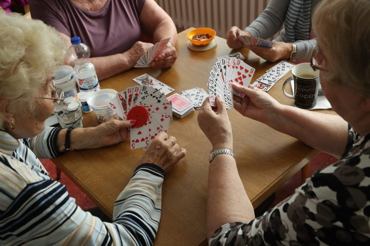 BERLIN, GERMANY - SEPTEMBER 20: Elderly women play a cards game of rummy at the Mireille Mathieu senior citizens' center on September 20, 2017 in Berlin, Germany. According to government staistics the overall population of approximately 82.3 million in Germany is predicted to decline over coming decades, while the country's population of those aged 67 and older is predicted to rise from 15.1 million in 2013 to 21.5 million by 2040, or 42%. This trend creates huge challenges for policymakers, who must adapt Germany's employment, welfare, senior care, health and pension systems to cope. The Mireille Mathieu center is one of many community centers across Berlin that offer programs, including physical exercise, language courses, computer classes and other activities for the elderly. (Photo by Sean Gallup/Getty Images)