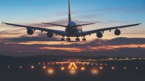 Photo of an airplane just before landing in the early morning sunrise.