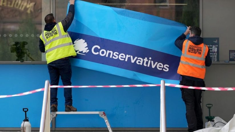 MANCHESTER, ENGLAND - OCTOBER 01: Workers erect Conservative Party branding on the windows of Manchester Central ahead of the Conservative party conference on October 01, 2021 in Manchester, England. The Conservative conference takes place between 3rd–6th October. (Photo by Christopher Furlong/Getty Images)