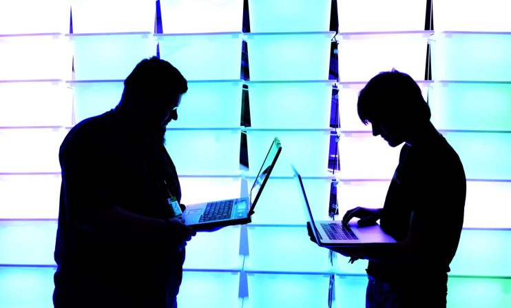 HAMBURG, GERMANY - DECEMBER 28: Participant hold their laptops in front of an illuminated wall at the annual Chaos Computer Club (CCC) computer hackers' congress, called 29C3, on December 28, 2012 in Hamburg, Germany. The 29th Chaos Communication Congress (29C3) attracts hundreds of participants worldwide annually to engage in workshops and lectures discussing the role of technology in society and its future. (Photo by Patrick Lux/Getty Images)