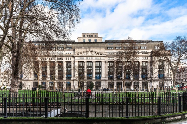 A building with a roman facade photographed from across a square